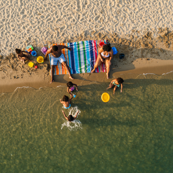 Top-down shot of a black family at the beach