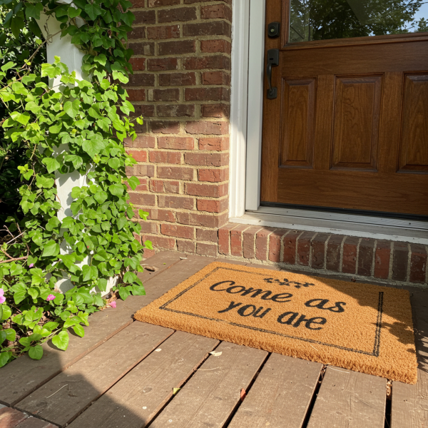 A doormat on a porch. the doormat says "come as you are" #3