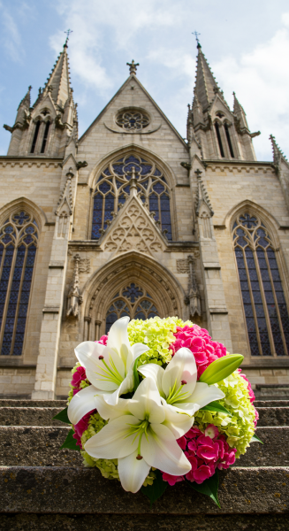 A wedding bouquet in front of a church