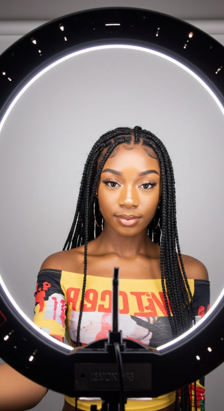 Young black female influencer taking a selfie with a ring light #3