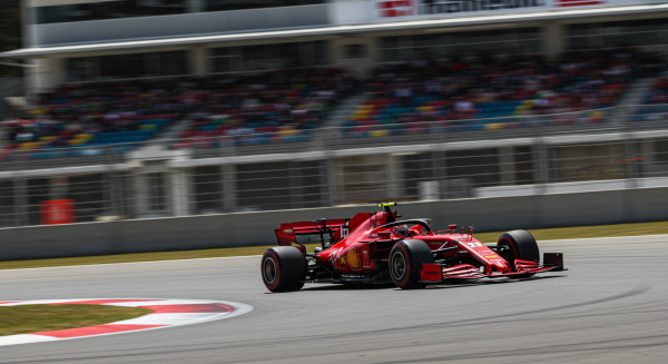 A red racing car speeding on a race track #3