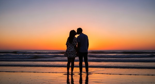 A shot of a young black man and woman kissing at the beach at dusk #4